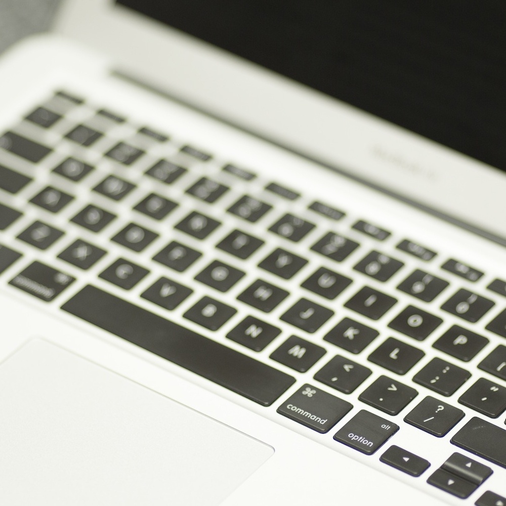 Macbook pro keyboard demonstrating graphic design services